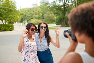 Image showing woman photographing her friends in summer park