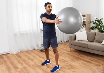 Image showing indian man exercising with fitness ball at home