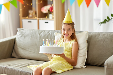 Image showing nice girl in party hat with birthday cake at home