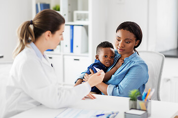 Image showing mother with sick baby son and doctor at clinic