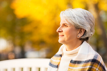 Image showing portrait of happy senior woman at autumn park