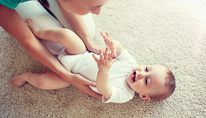 Image showing happy mother playing with baby at home