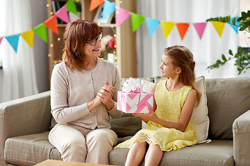 Image showing grandmother giving granddaughter birthday gift