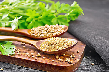 Image showing Coriander ground and seeds in two spoons on black board