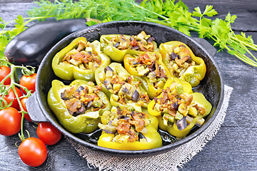 Image showing Pepper stuffed with vegetables in pan on black board