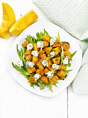 Image showing Salad of pumpkin and cheese in plate on light board top