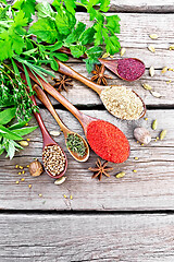 Image showing Spices in spoons on old board top