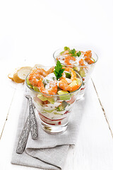 Image showing Salad with shrimp and avocado in two glasses on wooden board