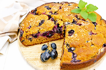 Image showing Pie with black grapes on light board