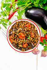 Image showing Lentils with eggplant in bowl on light board top