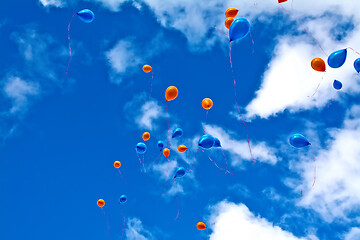 Image showing Balloons orange and blue in sky