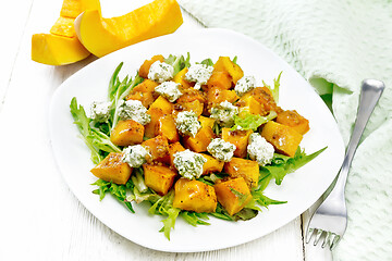 Image showing Salad of pumpkin and cheese in plate on white board