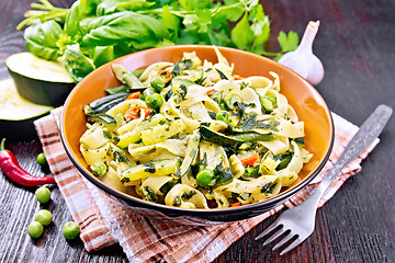 Image showing Tagliatelle with green vegetables on dark wooden board