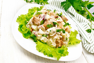 Image showing Salad of salmon and cucumber in plate on board