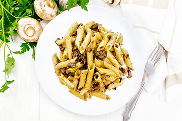 Image showing Pasta with mushrooms in white plate on board top