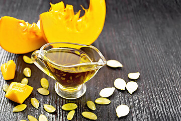 Image showing Oil pumpkin in gravy boat on board