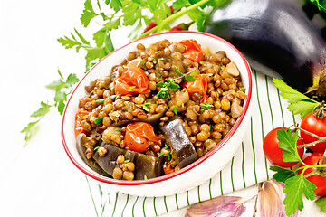 Image showing Lentils with eggplant in bowl on board