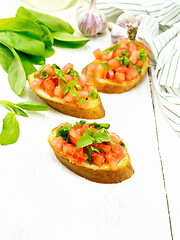 Image showing Bruschetta with tomato and spinach on light table