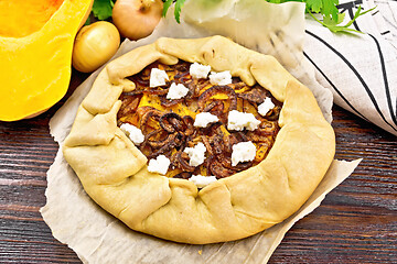 Image showing Pie with pumpkin and onions on dark board