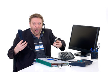 Image showing Stressed businessman on desk 