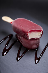 Image showing Fruit ice cream stick looks fresh to eat placed on black 