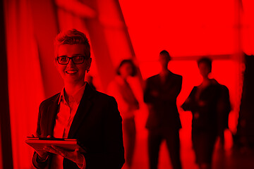 Image showing business woman  at office with tablet  in front  as team leader