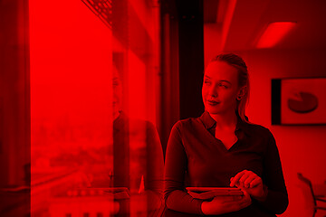 Image showing blonde businesswoman working on tablet at office