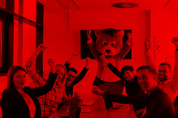 Image showing boss dresed as bear having fun with business people in trendy of