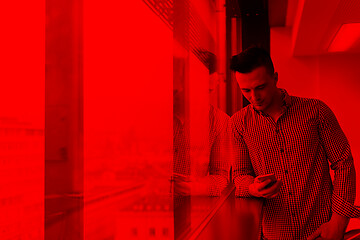 Image showing young business man using smart phone at office