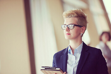 Image showing business woman  at office with tablet  in front  as team leader