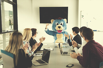 Image showing boss dresed as bear having fun with business people in trendy of