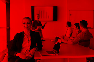 Image showing portrait of young business woman at office with team on meeting 