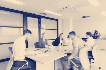 Image showing business people group entering meeting room  motion blur