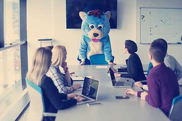 Image showing boss dresed as bear having fun with business people in trendy of