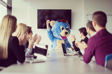 Image showing boss dresed as bear having fun with business people in trendy of