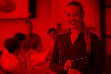 Image showing blonde businesswoman working on tablet at office