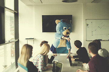 Image showing boss dresed as bear having fun with business people in trendy of