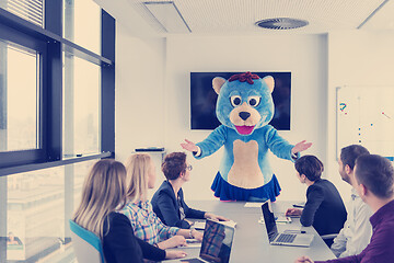 Image showing boss dresed as bear having fun with business people in trendy of