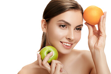 Image showing portrait of attractive caucasian smiling woman isolated on white studio shot eating green apple