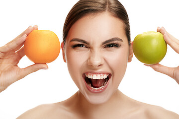 Image showing portrait of attractive caucasian smiling woman isolated on white studio shot eating green apple