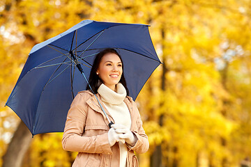 Image showing happy woman with umbrella in autumn park