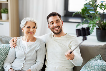 Image showing senior mother with adult son taking selfie at home