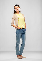 Image showing happy asian woman over grey background