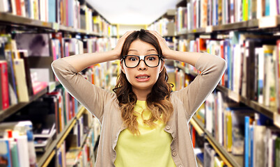 Image showing asian female student holding to head at library