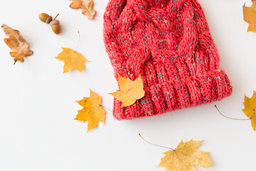 Image showing hat and fallen autumn leaves on white background