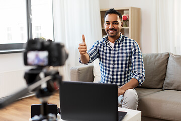 Image showing male blogger with camera videoblogging at home