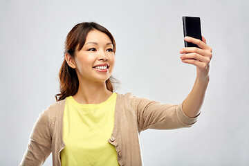 Image showing asian woman taking selfie by smartphone