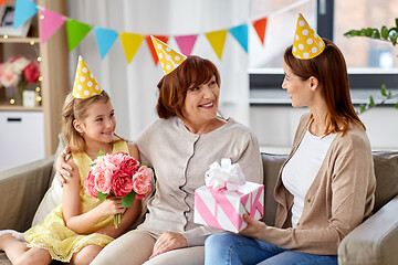 Image showing mother with gift greeting grandmother on birthday