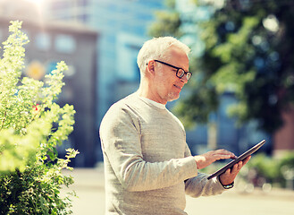 Image showing senior man with tablet pc on city street