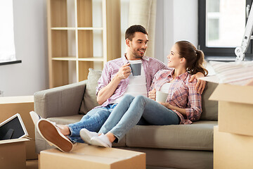 Image showing happy couple drinking coffee moving to new home